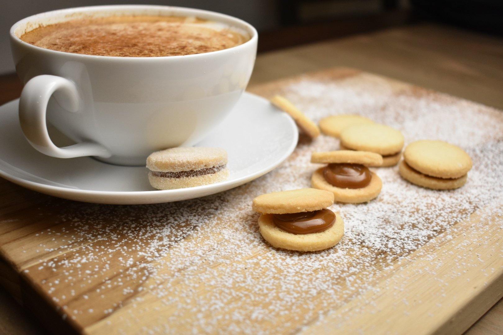 Dulce De Leche Cookies and a cup of coofee on a cutting board